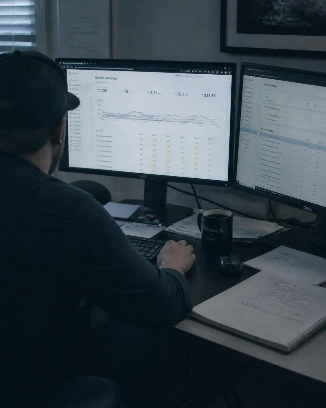 Specialist reviewing search ranking reports across two monitors